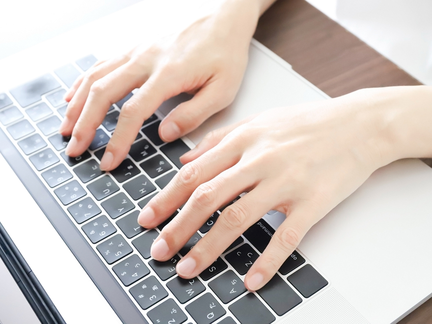 キーボードでタイピング練習をしている手の写真